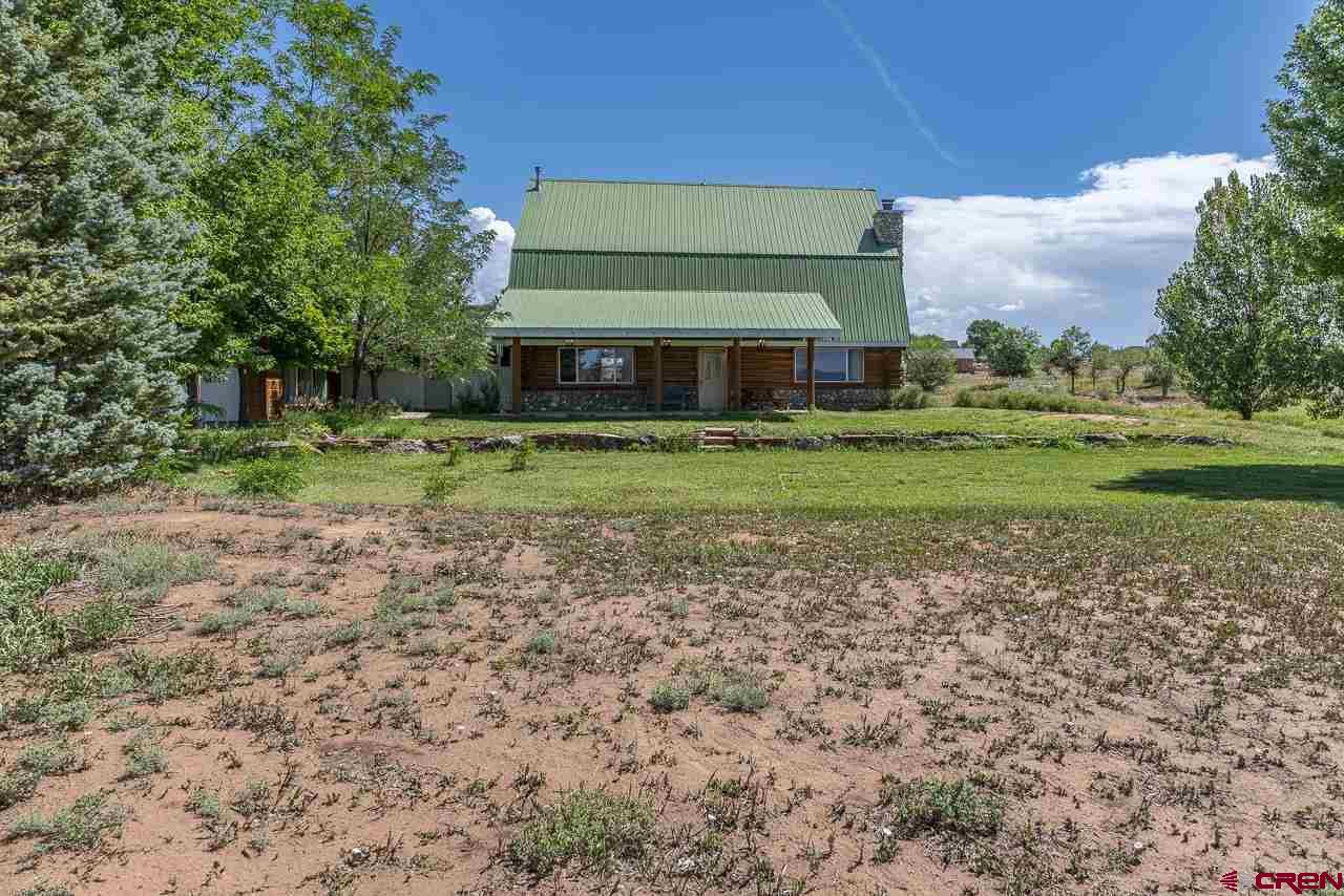 25558 Rd N 6 Loop Cortez, CO 81321 - Photo 27 of 30 a front view of a house with a yard