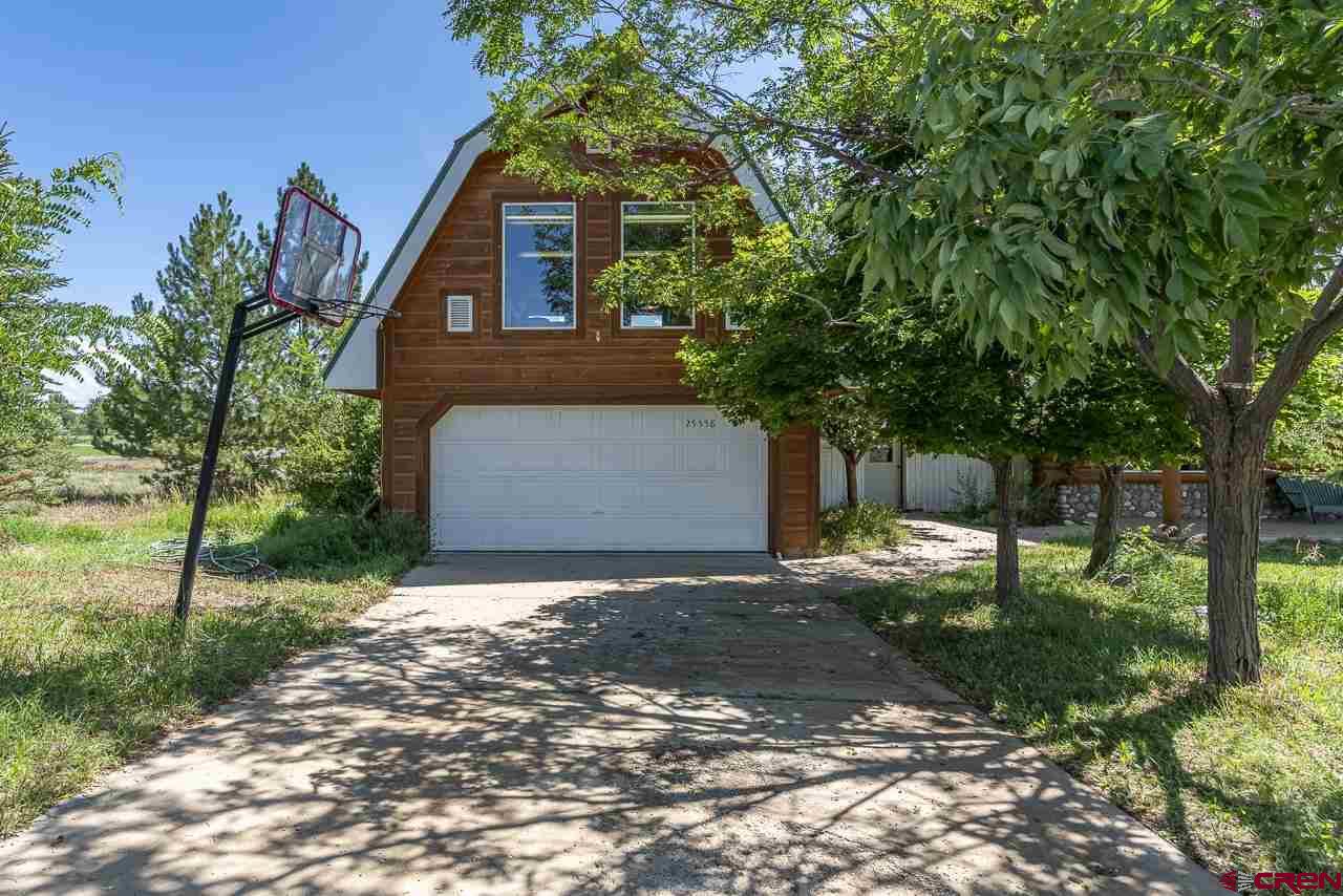 25558 Rd N 6 Loop Cortez, CO 81321 - Photo 3 of 30 a front view of a house with a yard and tree