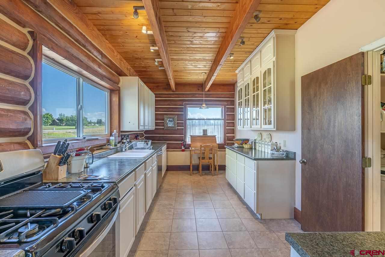 25558 Rd N 6 Loop Cortez, CO 81321 - Photo 10 of 30 a kitchen with sink stove and cabinets