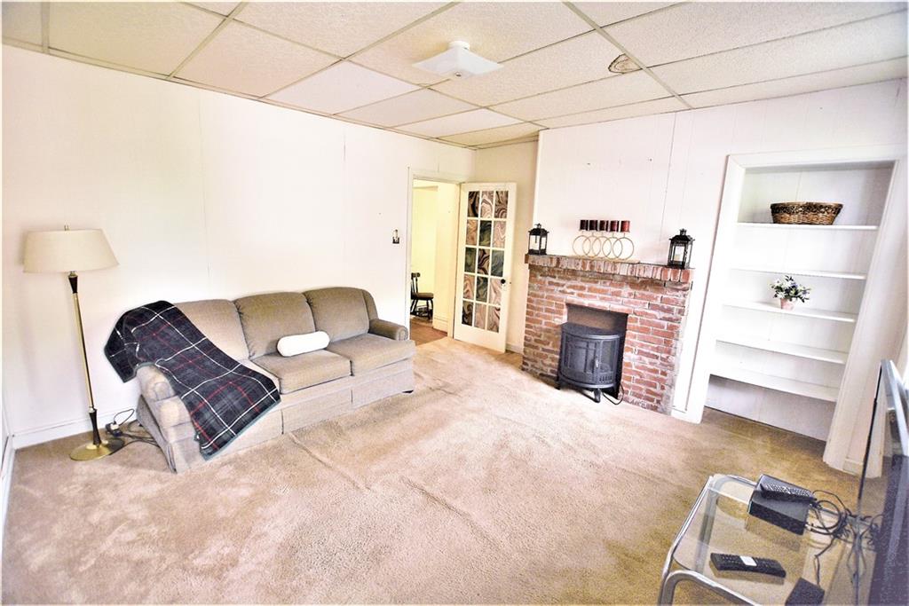 2517 Mt Troy Road Pittsburgh, PA 15212 - Photo 8 of 40 Second floor living room from closet area. Brick decorative fireplace. Glass panel door leads into the hallway (IS NOT INCLUDED IN THE SALE).