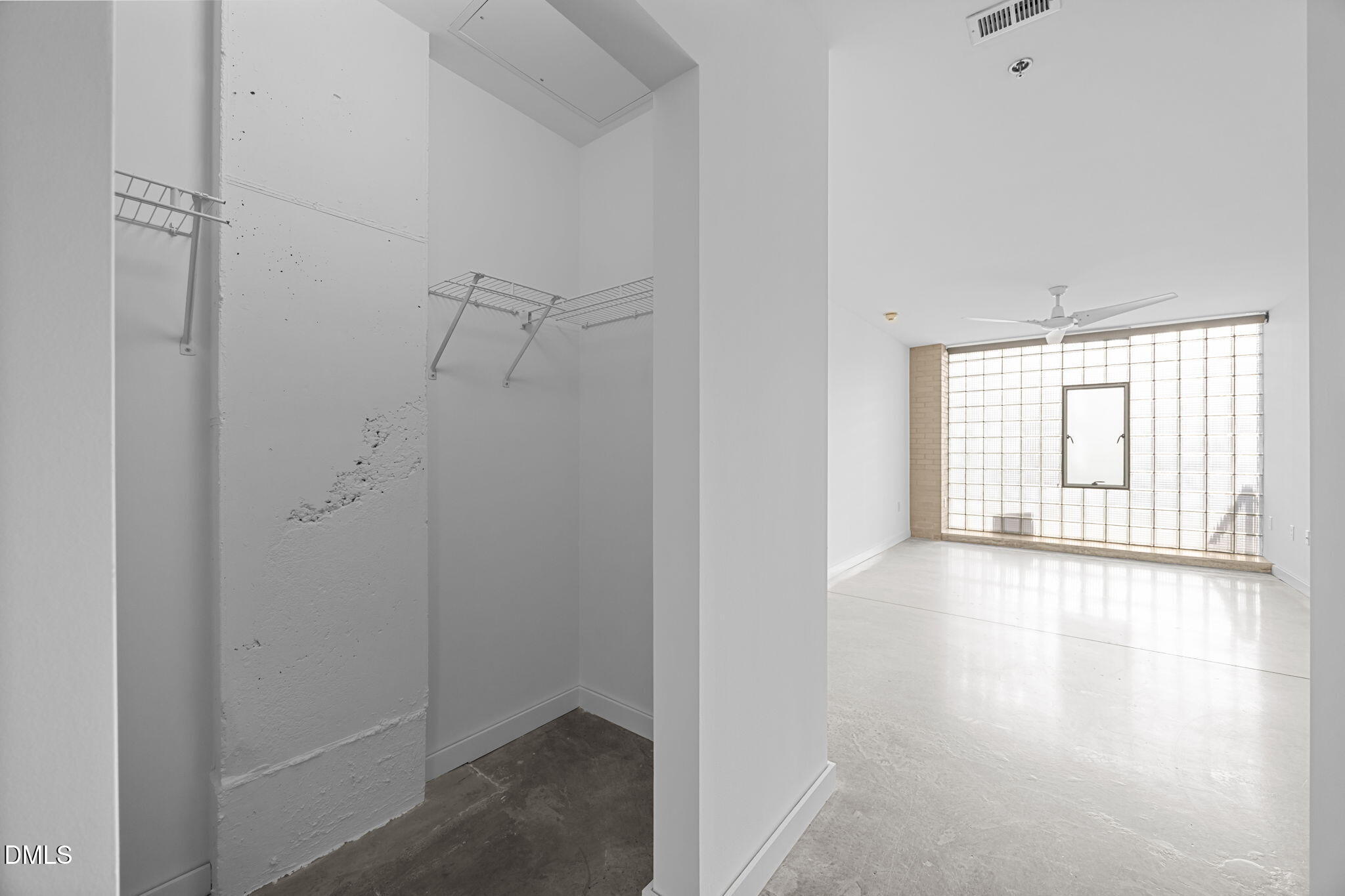 319 Fayetteville Street, Unit 210 Raleigh, NC 27601 - Photo 25 of 61 a view of an empty room with wooden floor and a window