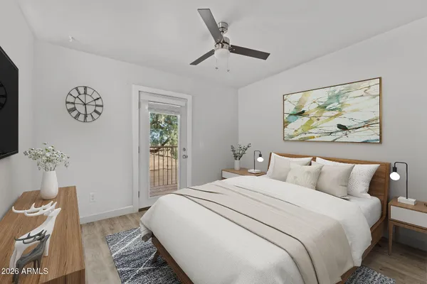 a bedroom with a bed and a painting on the wall