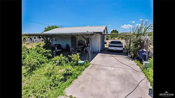 a view of a house with potted plants