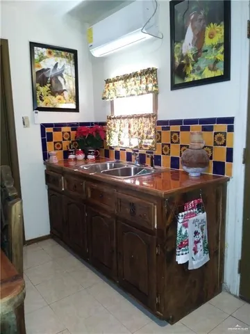 a room with a painting on the wall and a sink