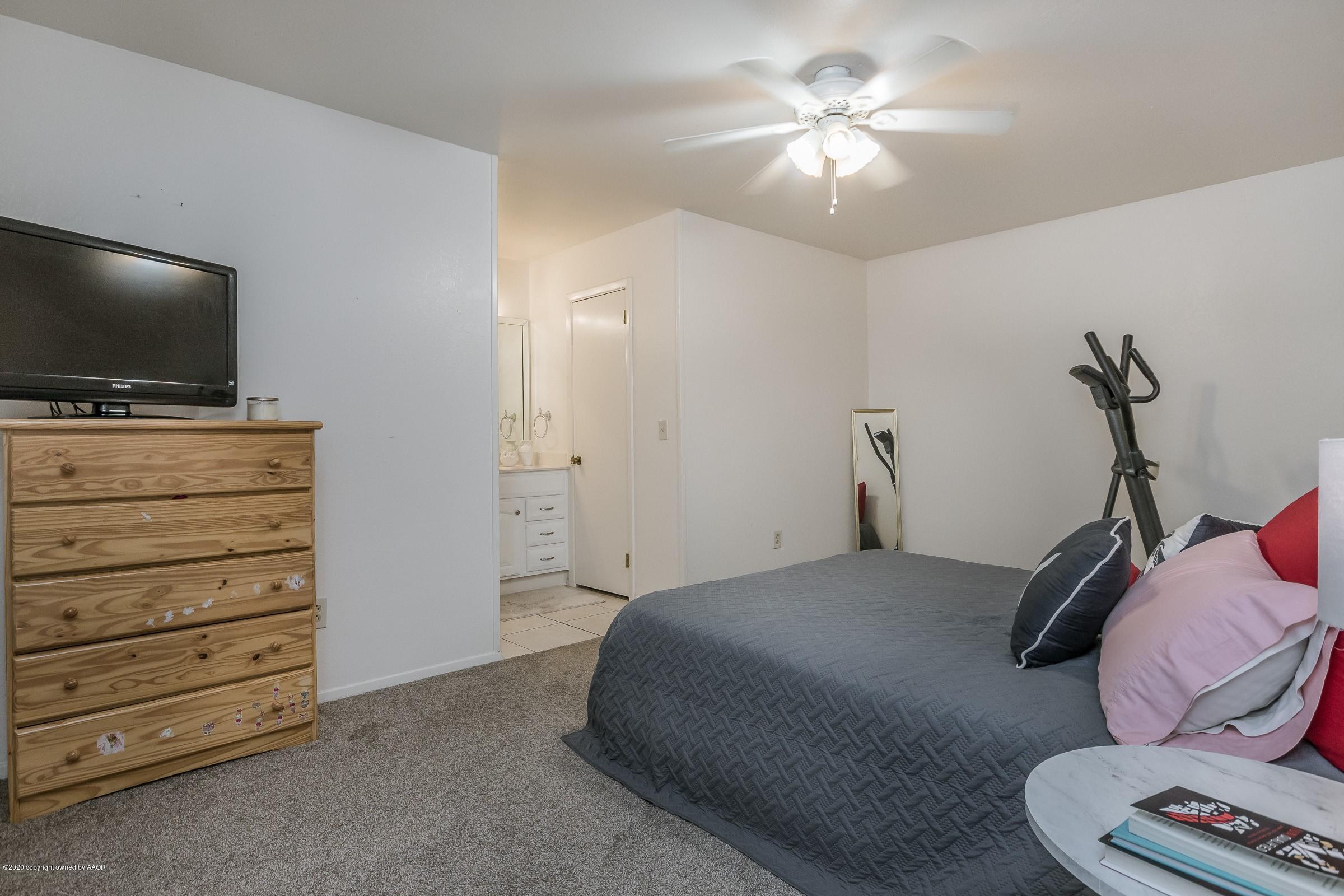 2818 Porter Drive Amarillo, TX 79110 - Photo 11 of 24 a bedroom with a bed and a flat screen tv