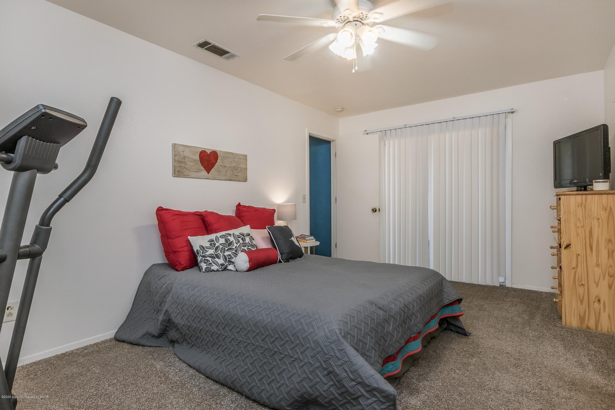 2818 Porter Drive Amarillo, TX 79110 - Photo 12 of 24 a bedroom with a bed and a flat screen tv