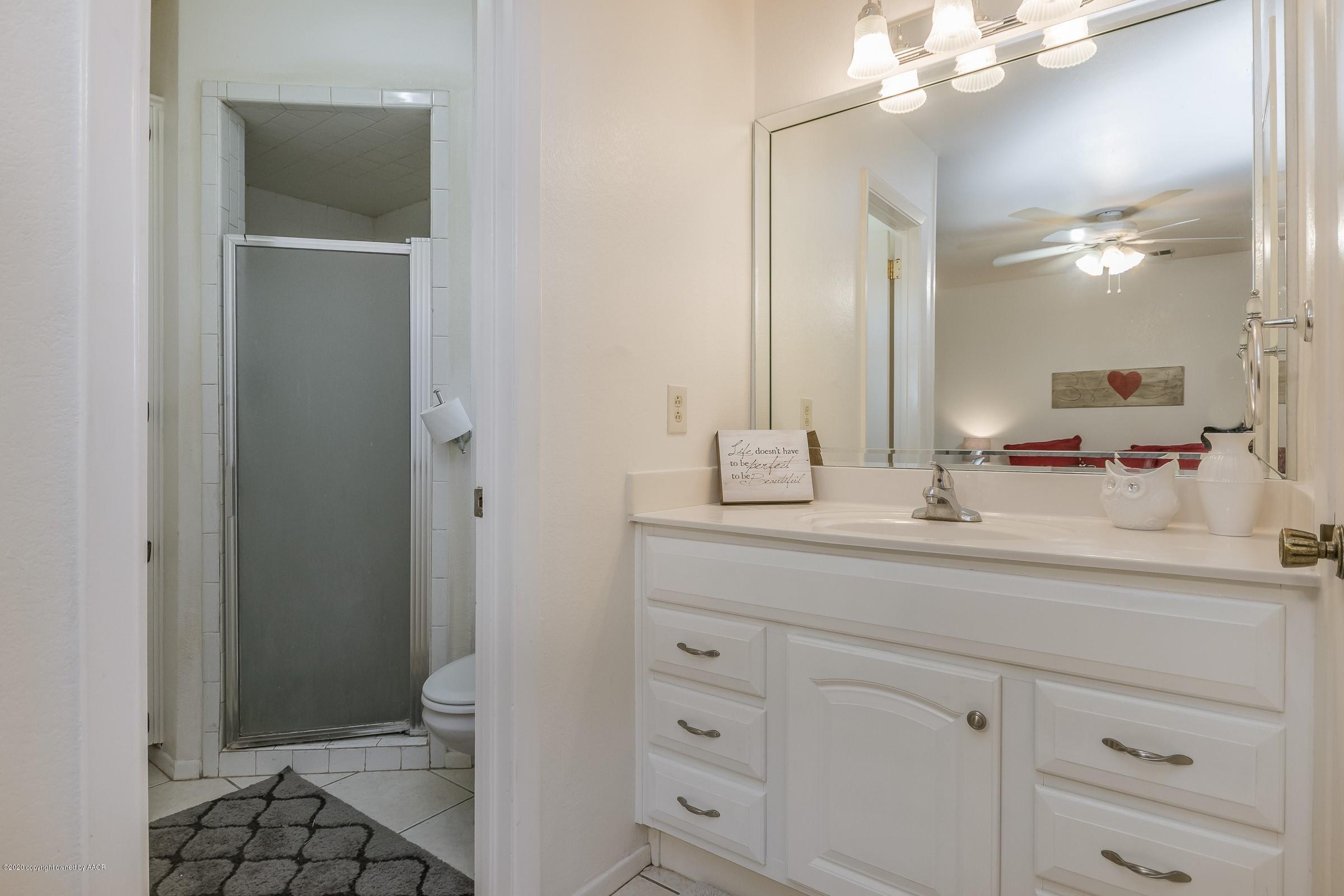 2818 Porter Drive Amarillo, TX 79110 - Photo 13 of 24 a bathroom with a sink a toilet and shower
