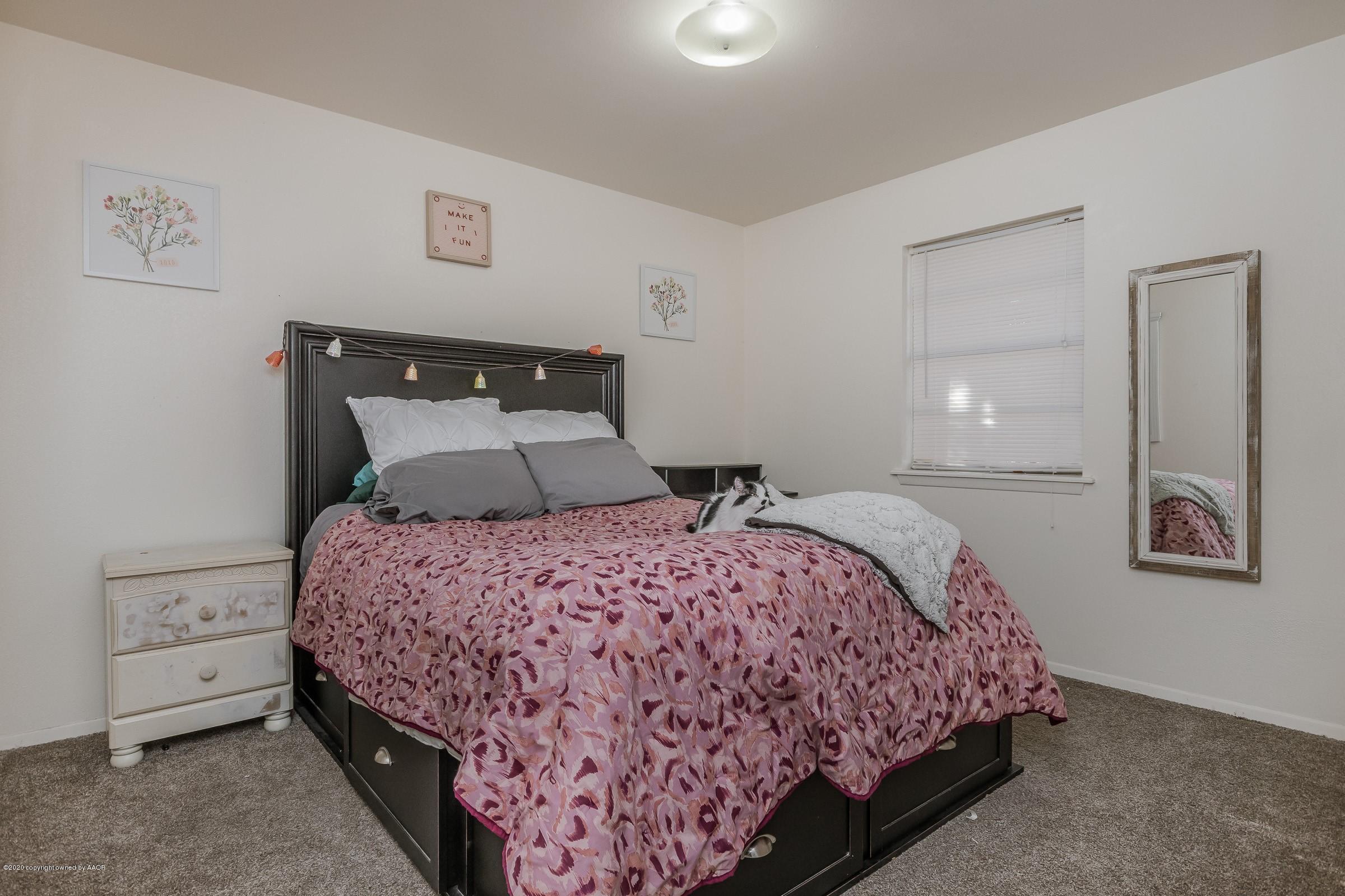 2818 Porter Drive Amarillo, TX 79110 - Photo 16 of 24 a bedroom with a bed and a lamp on table