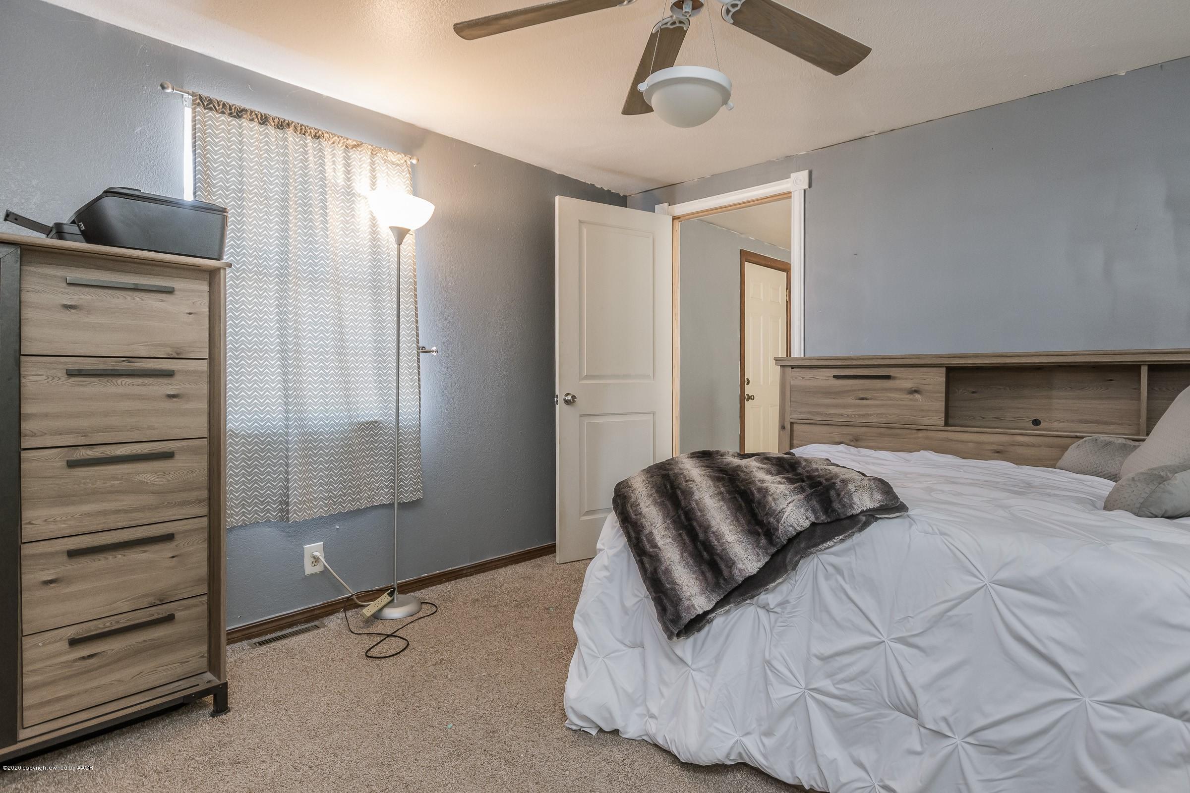 2818 Porter Drive Amarillo, TX 79110 - Photo 18 of 24 a bedroom with a bed and a walk in closet
