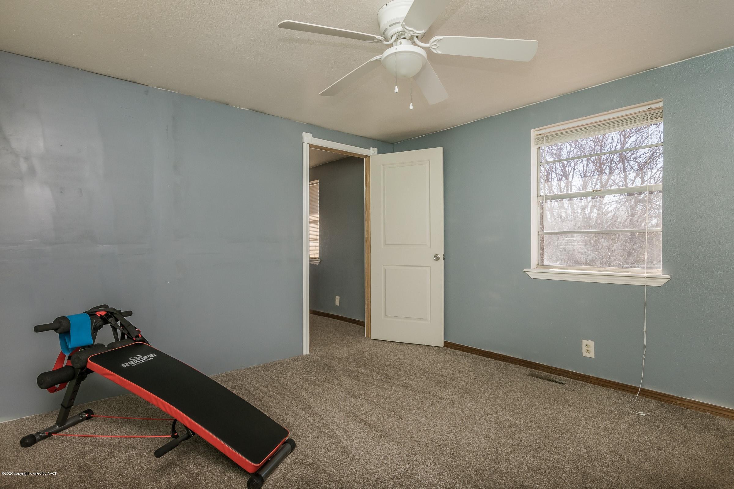 2818 Porter Drive Amarillo, TX 79110 - Photo 19 of 24 a room with gym equipment and windows