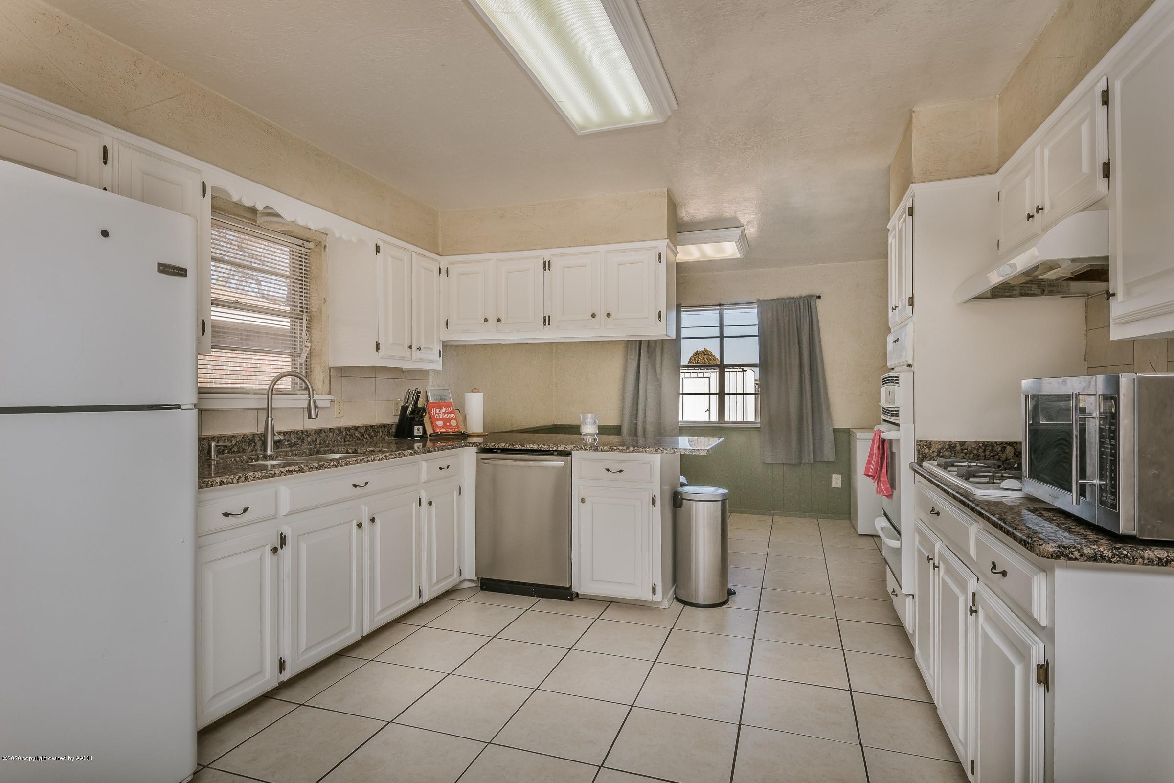2818 Porter Drive Amarillo, TX 79110 - Photo 3 of 24 a kitchen with a sink stove and cabinets