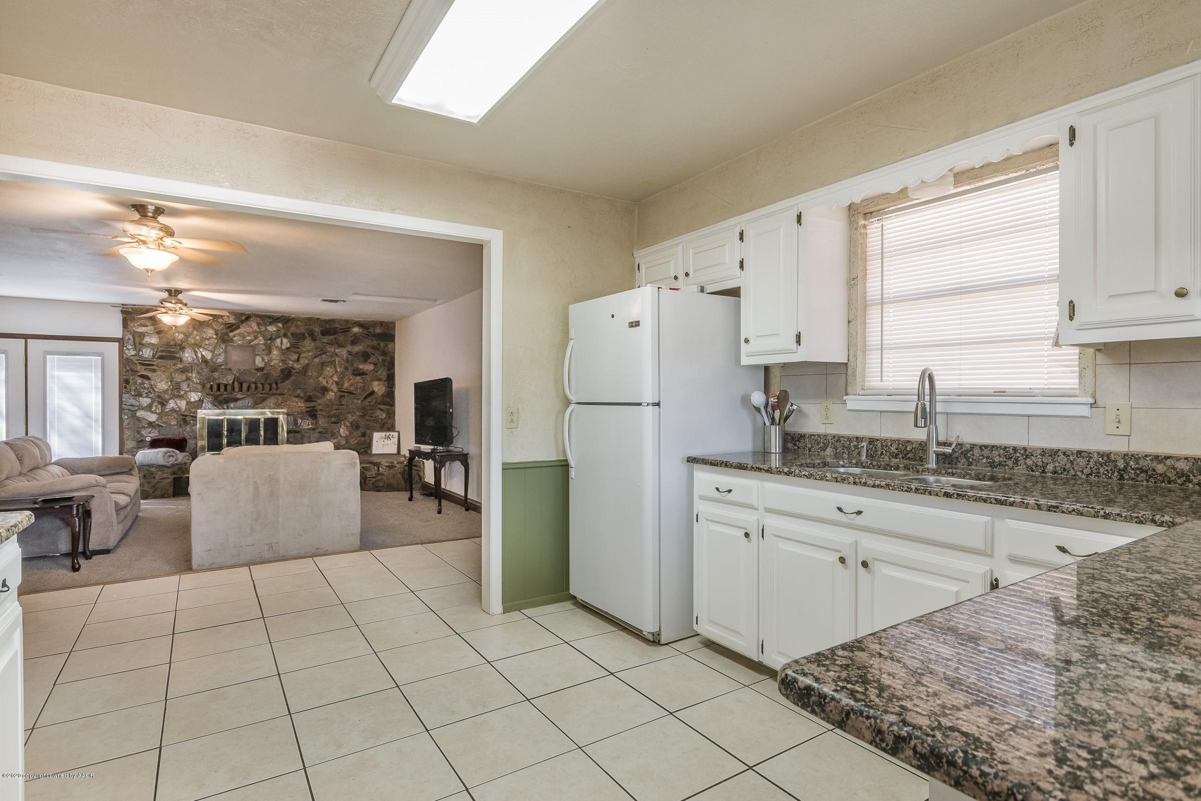 2818 Porter Drive Amarillo, TX 79110 - Photo 8 of 24 a kitchen with stainless steel appliances granite countertop a refrigerator sink and stove