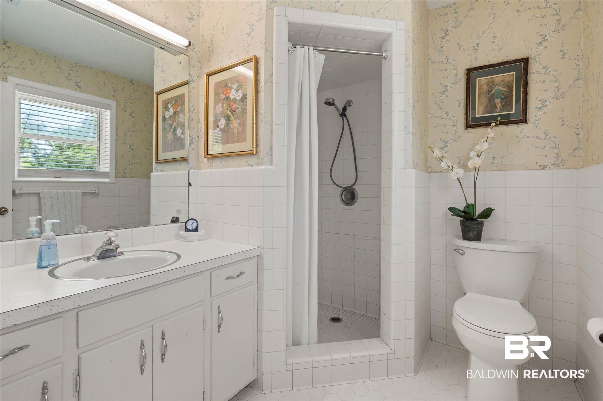 706 Sutherland Drive Chickasaw, AL 36611 - Photo 15 of 33 Bathroom featuring wainscoting, wallpapered walls, and tile walls