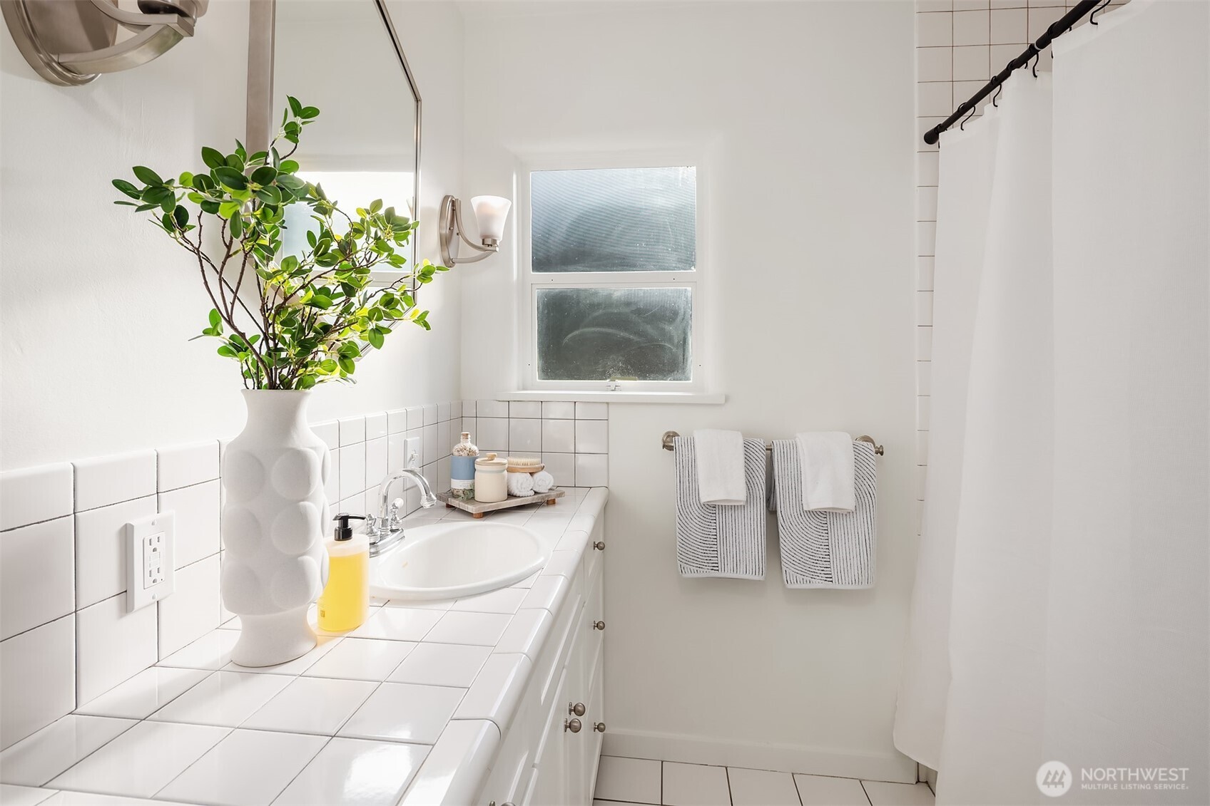 7920 5th Avenue Northeast Seattle, WA 98115 - Photo 15 of 31 a bathroom with a sink a mirror and vanity