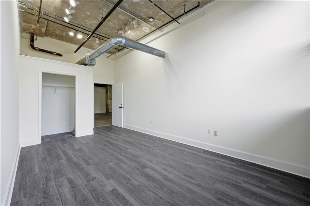 505 Whitehall Street Southwest, Unit 101 Atlanta, GA 30303 - Photo 12 of 31 a view of a room with wooden floor and a ceiling fan