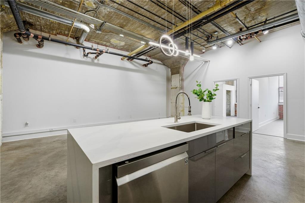 505 Whitehall Street Southwest, Unit 101 Atlanta, GA 30303 - Photo 2 of 31 a kitchen with a sink and chandelier