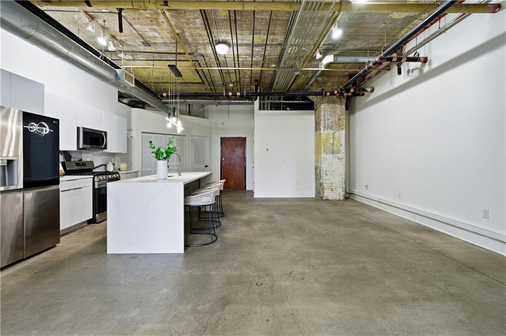 505 Whitehall Street Southwest, Unit 101 Atlanta, GA 30303 - Photo 8 of 31 a view of a kitchen with furniture and a window