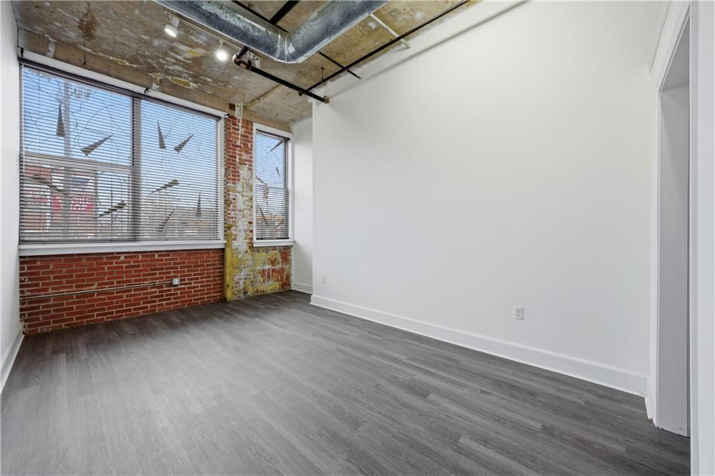 505 Whitehall Street Southwest, Unit 101 Atlanta, GA 30303 - Photo 10 of 31 a view of a room with wooden floor and window