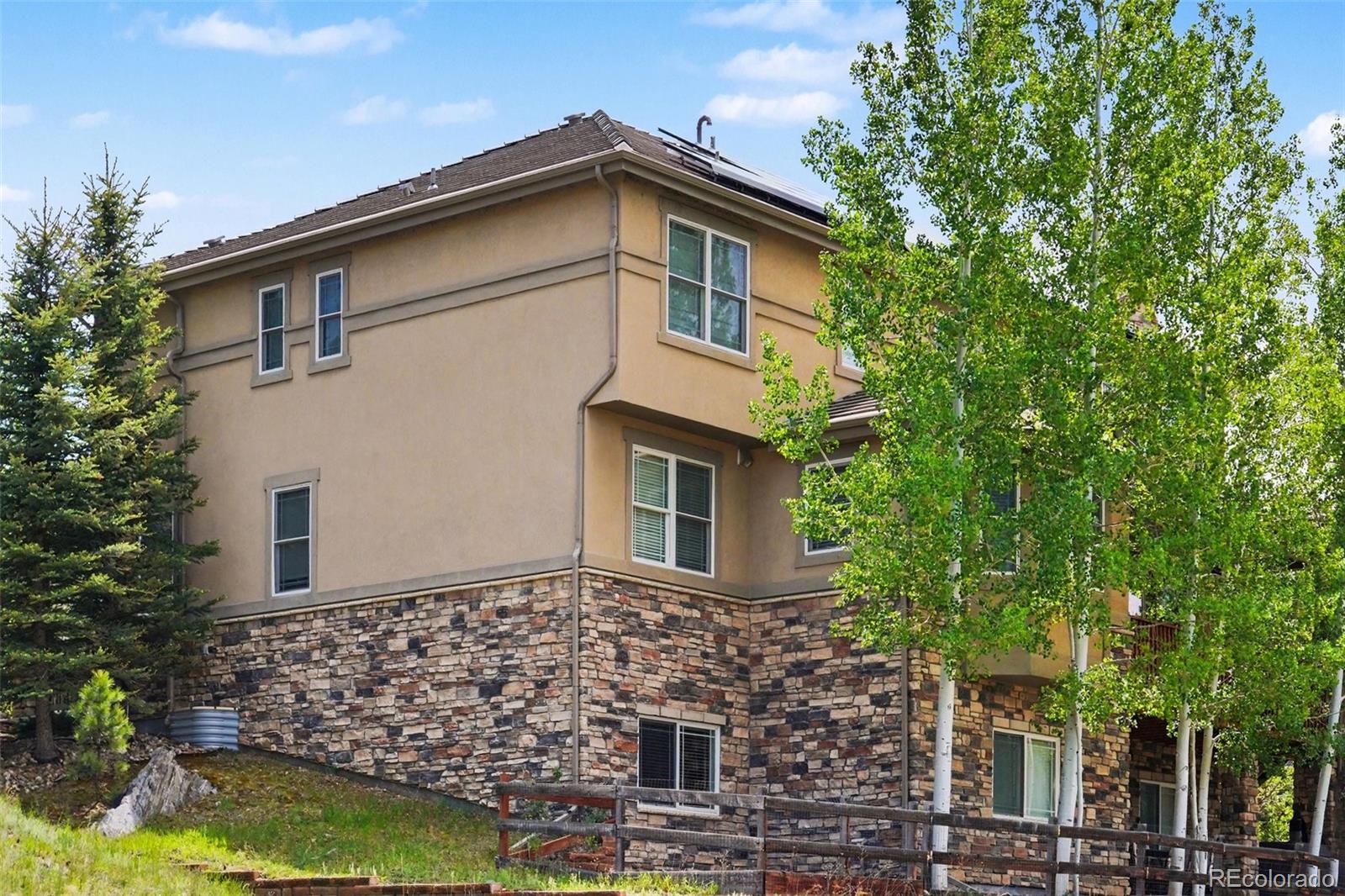 791 Elk Rest Road Evergreen, CO 80439 - Photo 40 of 46 a front view of a house with garden