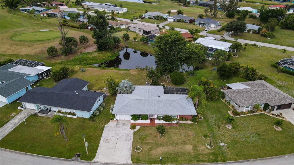 an aerial view of residential houses with outdoor space and parking