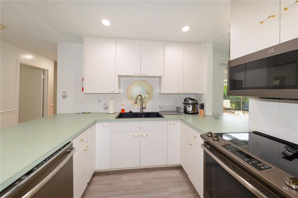 124 Caddy Road Rotonda West, FL 33947 - Photo 13 of 41 a kitchen with a sink stove and cabinets