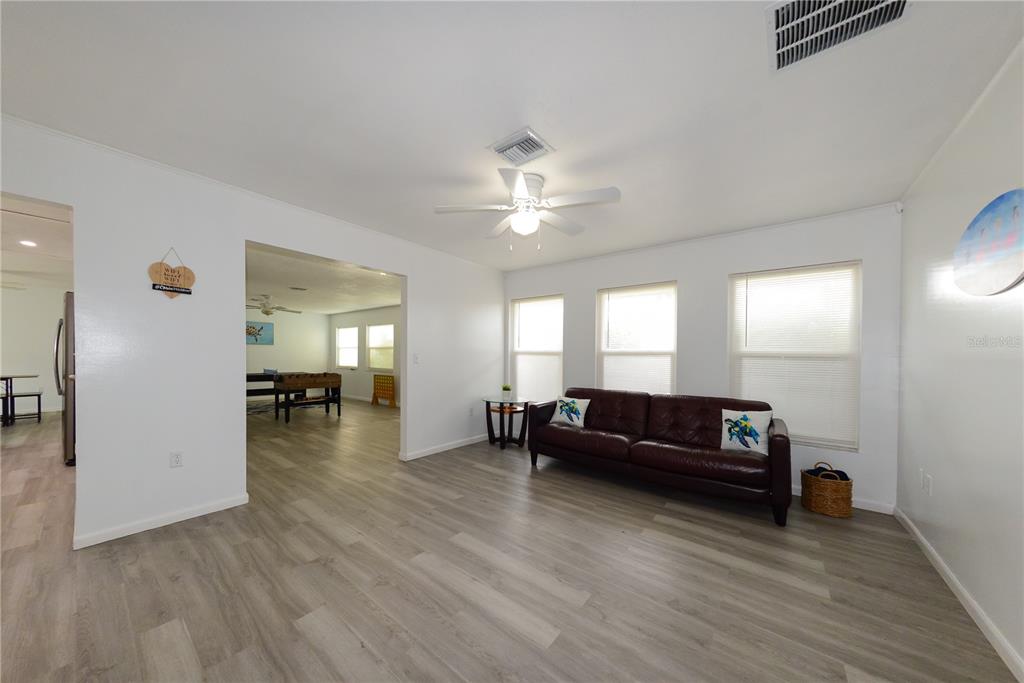 124 Caddy Road Rotonda West, FL 33947 - Photo 18 of 41 a living room with furniture and wooden floor