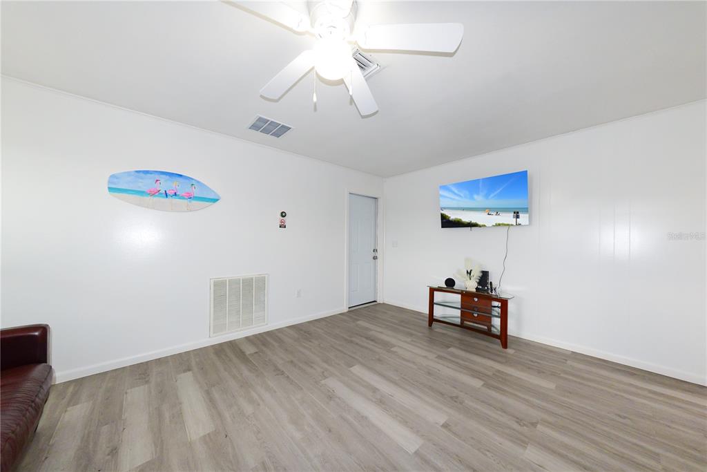 124 Caddy Road Rotonda West, FL 33947 - Photo 19 of 41 a view of a livingroom with furniture and a ceiling fan