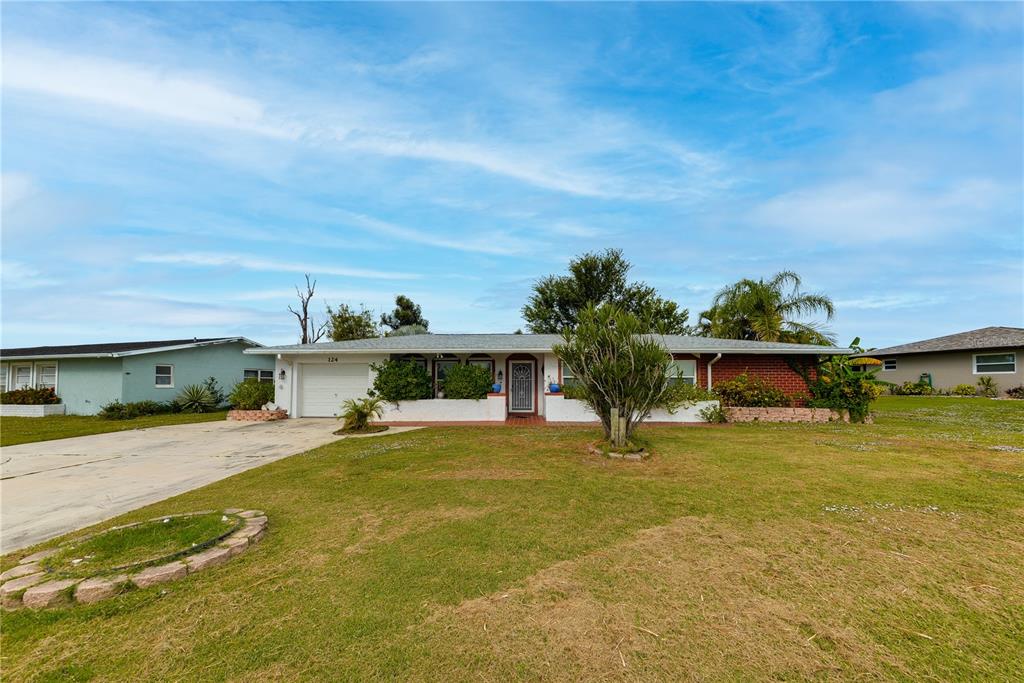 124 Caddy Road Rotonda West, FL 33947 - Photo 2 of 41 a swimming pool with yard outdoor seating and yard in back