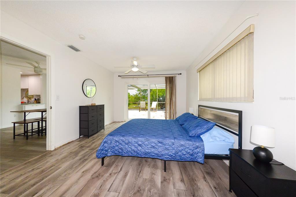 124 Caddy Road Rotonda West, FL 33947 - Photo 22 of 41 a living room with a bed furniture and a large window
