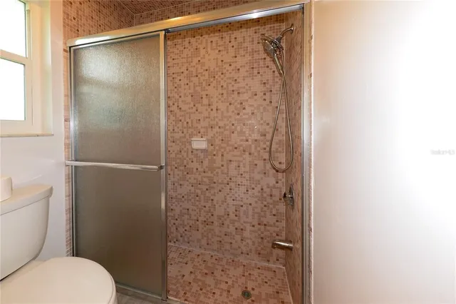 a bathroom with a shower and a toilet