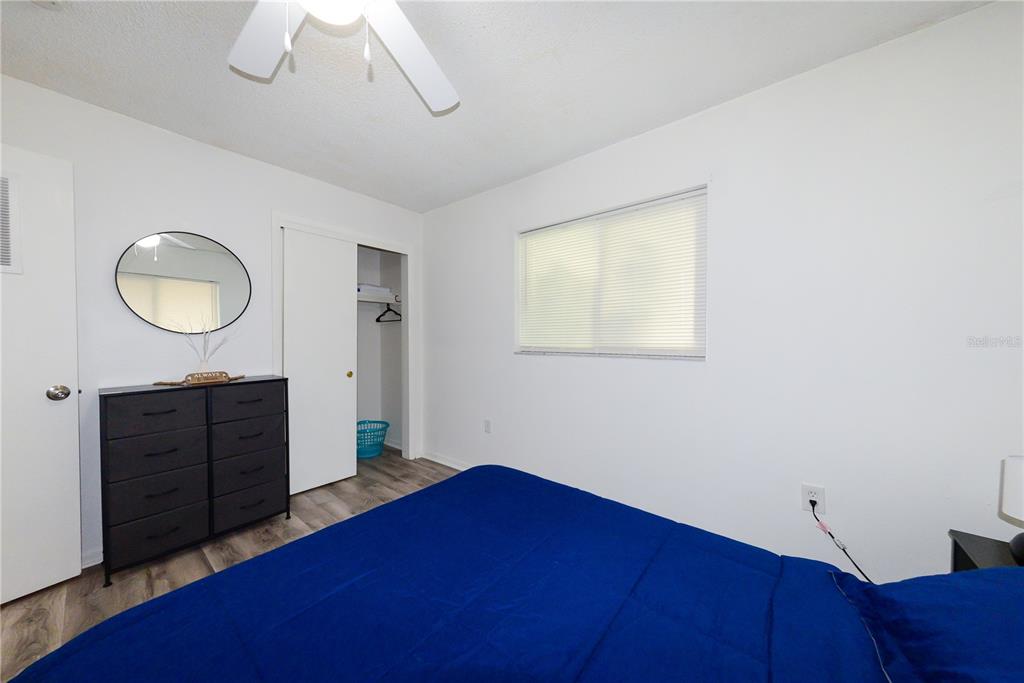 124 Caddy Road Rotonda West, FL 33947 - Photo 32 of 41 a bedroom with a bed and a dresser