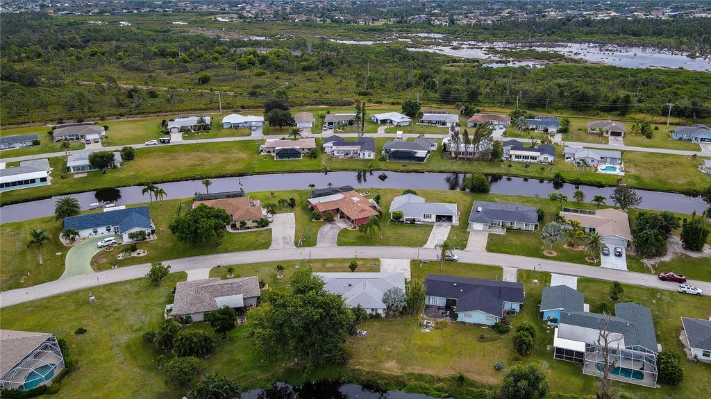124 Caddy Road Rotonda West, FL 33947 - Photo 40 of 41 an aerial view of a houses with a lake view