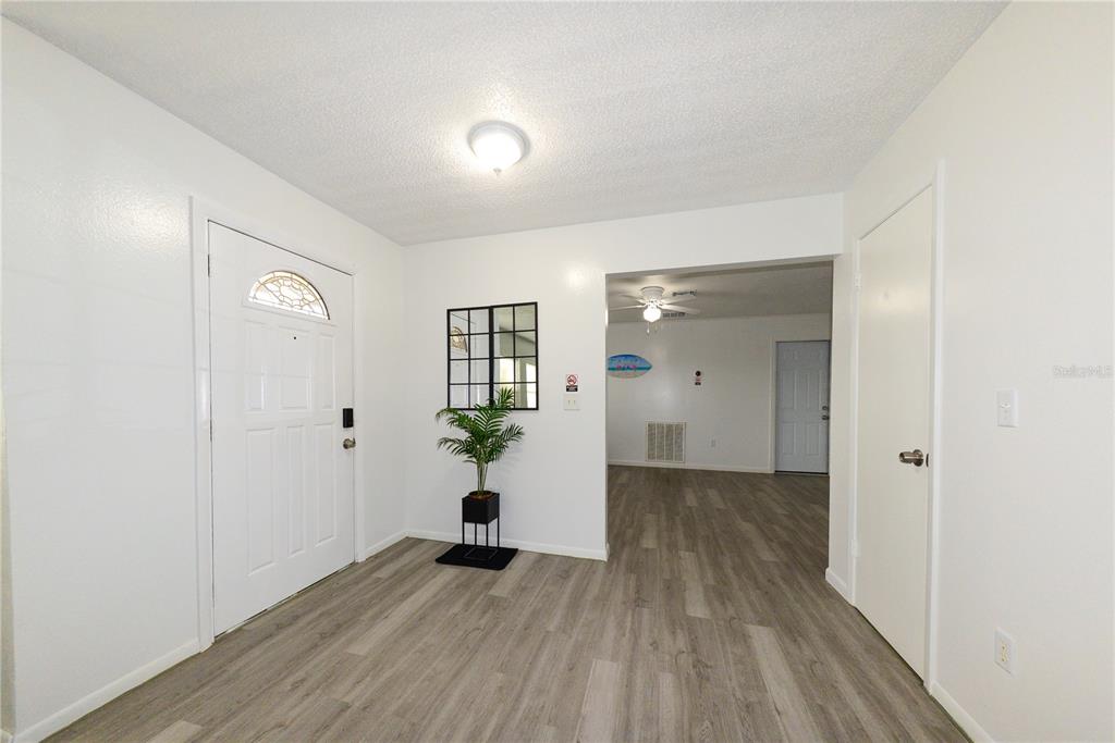 124 Caddy Road Rotonda West, FL 33947 - Photo 4 of 41 wooden floor in an empty room