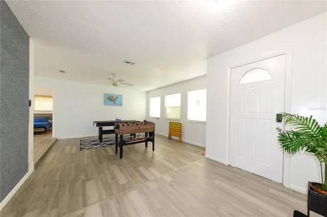 a dining room with furniture and wooden floor