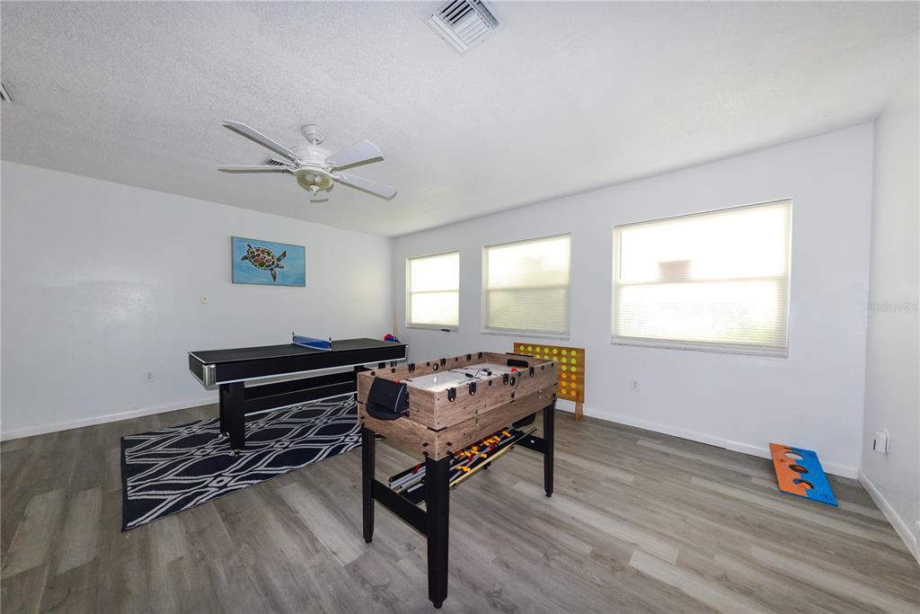 124 Caddy Road Rotonda West, FL 33947 - Photo 7 of 41 a living room with furniture a air conditioner vent and a window