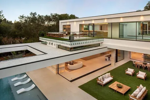 a front view of a house with a garden