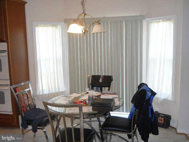 3602 Lions Field Road Triangle, VA 22172 - Photo 7 of 22 a view of a dining room with furniture and a window