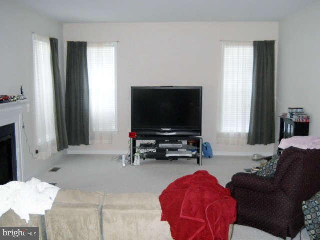 3602 Lions Field Road Triangle, VA 22172 - Photo 8 of 22 a living room with furniture and a flat screen tv