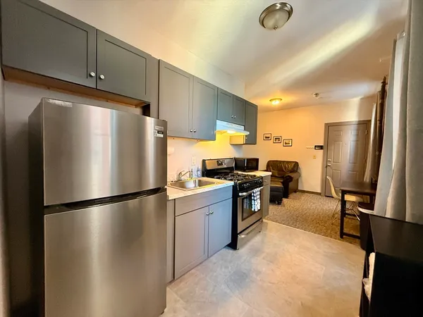 a kitchen with refrigerator and car