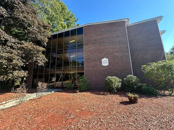 a backyard of a house with barbeque oven and outdoor seating