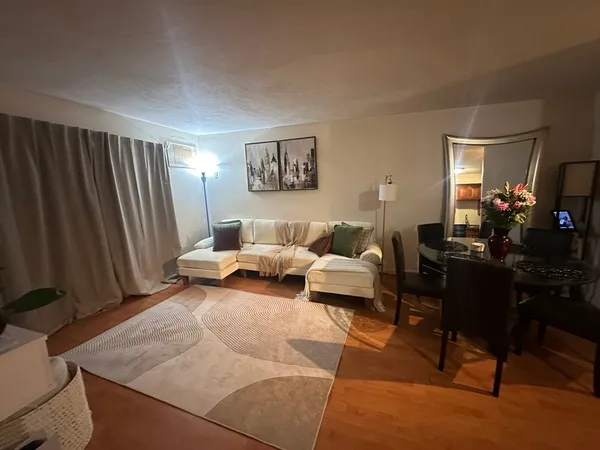 a living room with furniture and a mirror