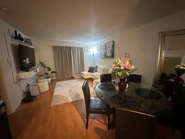 a dining room with furniture and wooden floor
