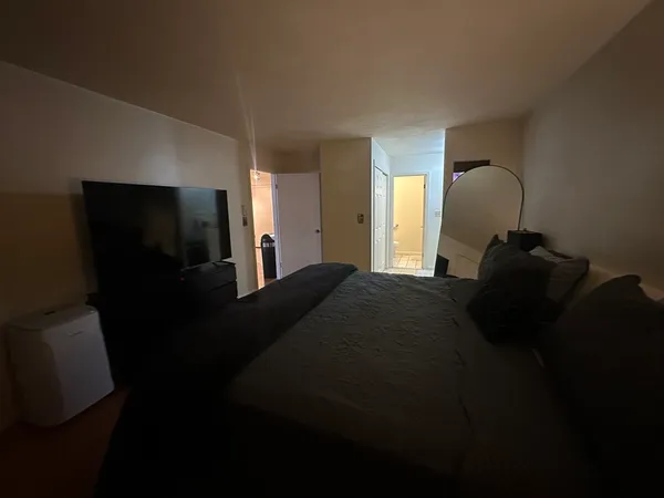 a bedroom with a bed and a mirror