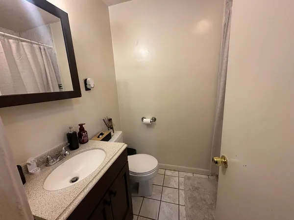 a bathroom with a sink a toilet and mirror