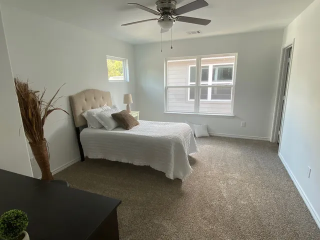 a bedroom with a bed and window