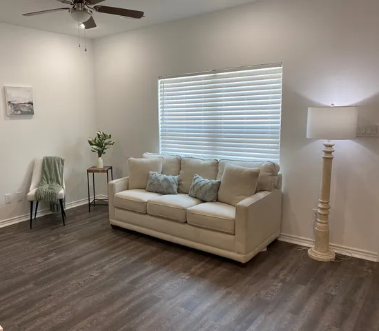 a living room with furniture and a window