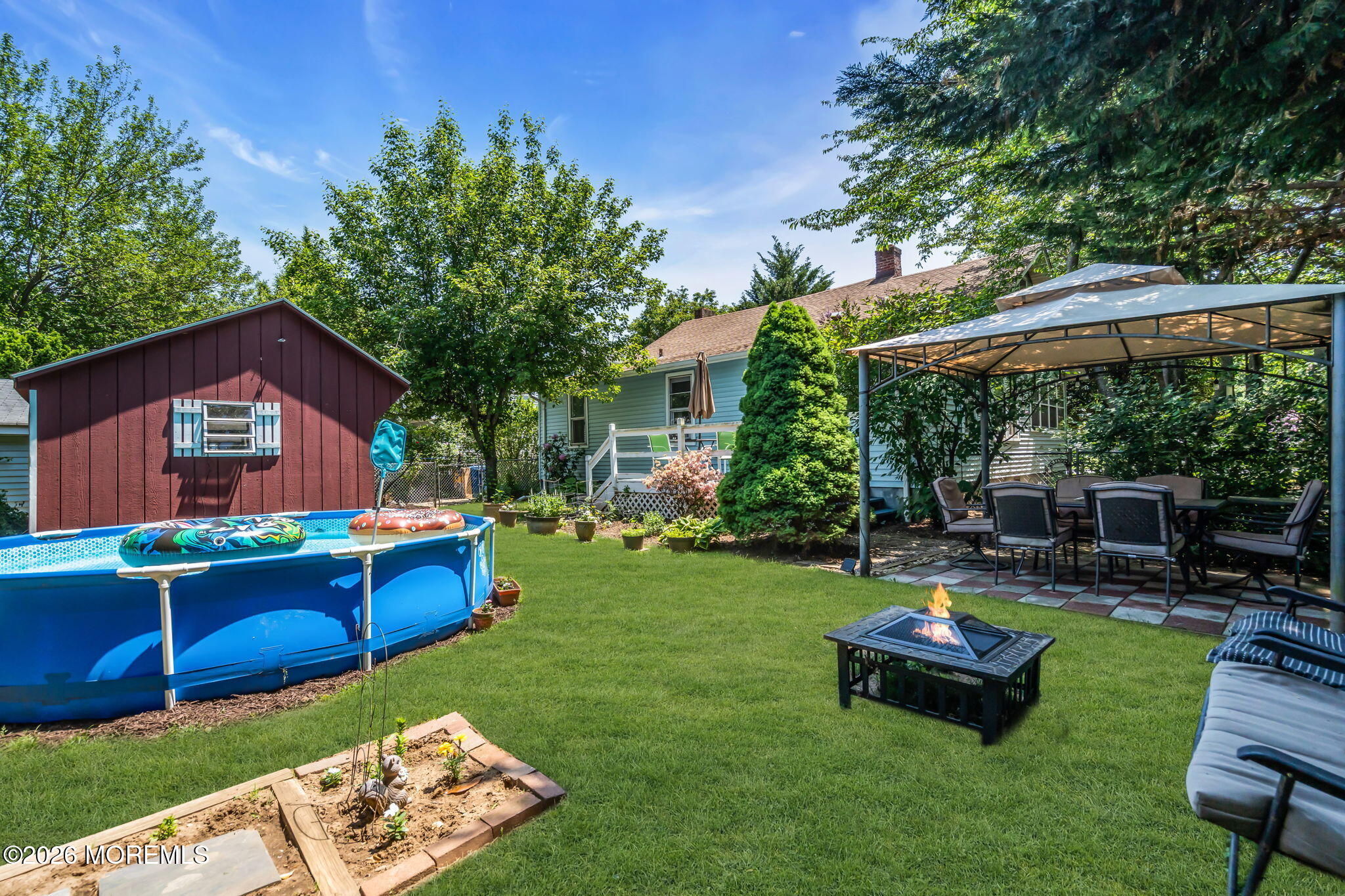 24 Foster Street Middletown, NJ 07701 - Photo 20 of 23 a view of a house with backyard sitting area and garden