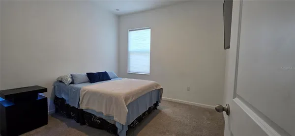 a bedroom with a bed and window