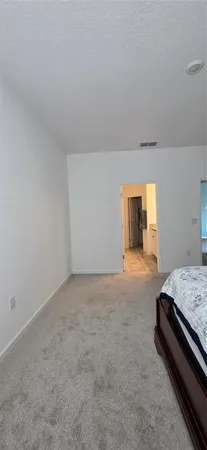 a bedroom with a bed and dresser
