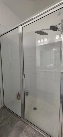 a bathroom with a glass shower door